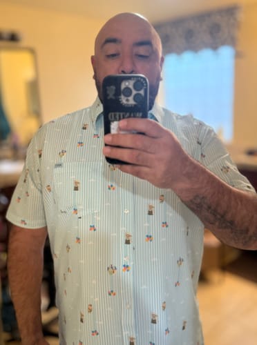 Reviewer taking a mirror selfie to show the fit of the 'Going Up!' short sleeve shirt.