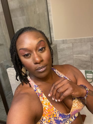 Close-up of a reviewer wearing the v-neck Chakra Regular Bra, showing its colorful pattern.