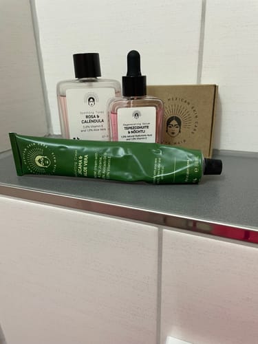 Customer's Barrier Protection Routine products, including a cream, toner, and serum, arranged on a bathroom counter.