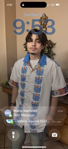 Customer wearing the white Talavera Corazones Guayebera Shirt with a blue collar and heart patterns.