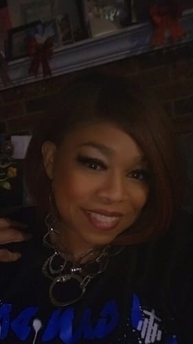 Customer wearing the Sensationnel Kinky Bob wig, styled in a vibrant, asymmetrical cut.