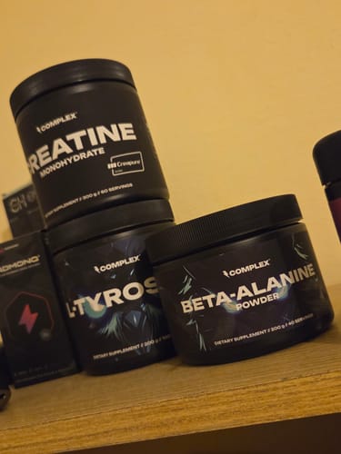 Customer's tub of Complex Creapure Creatine on a wooden shelf with other Complex brand supplements.