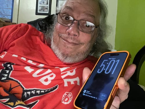 Customer holding an iPhone fitted with the metallic orange MagCase Metal.