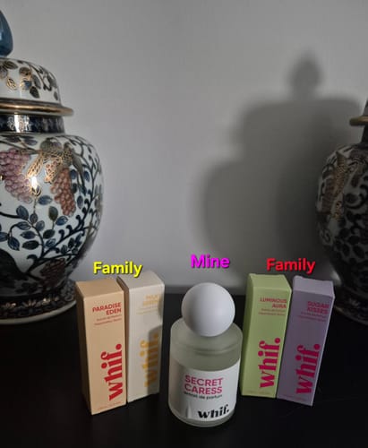 Reviewer's collection of Whif perfumes, showing their 'Secret Caress' bottle and four boxed scents for family.