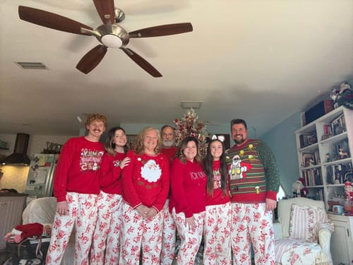 Reviewer's family posing in matching red 'Making Memories Together' sweatshirts in their home for Christmas.