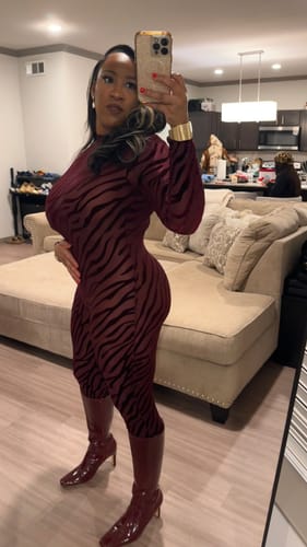 Close-up mirror selfie of a reviewer in the red patterned Burnout Closed Toe Jumpsuit.