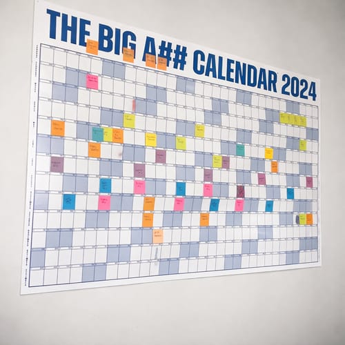 Customer's THE BIG A## CALENDAR on a wall, filled with many colorful planning labels.