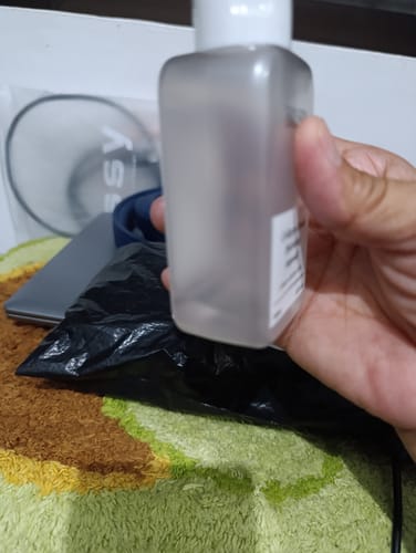 Close-up of a reviewer holding the frosted bottle of Bad Skin Korean Collagen Bomb Hydrating Ampoule.