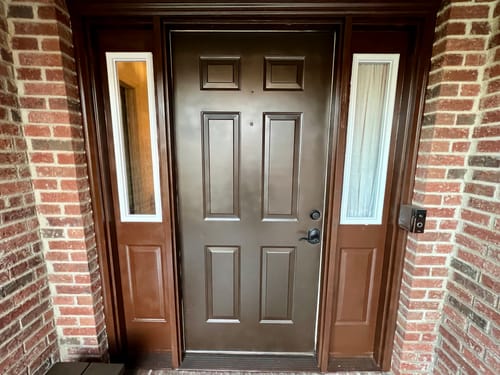 Customer's two white Clear 1 Lite Glass and Frame Kits installed on the sidelites of a brown front door.
