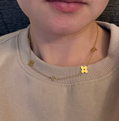 A customer's close-up view of the gold Tori Petal Necklace being worn.