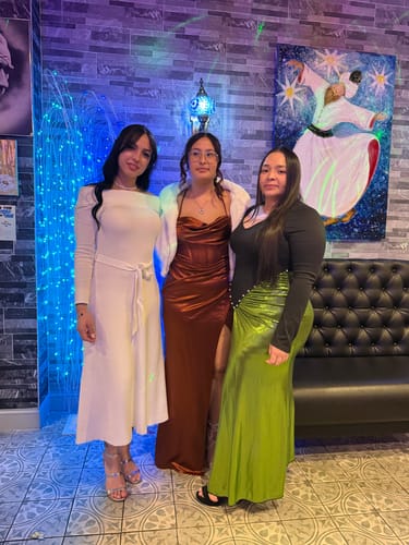 Reviewer on the left wearing the ivory Zoya Off Shoulder Ribbed Midi Dress at an event.