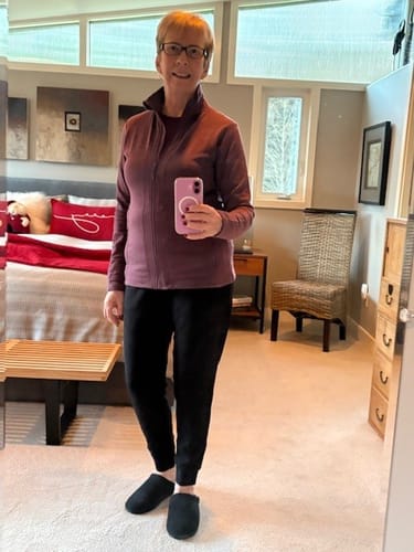 Reviewer showing the fit of the black Willa Joggers Petite, which have a relaxed style and cuffed ankles.