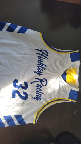 Customer's white custom basketball jersey with blue and yellow trim, personalized with 'Hinkley Racing' and the number 32.