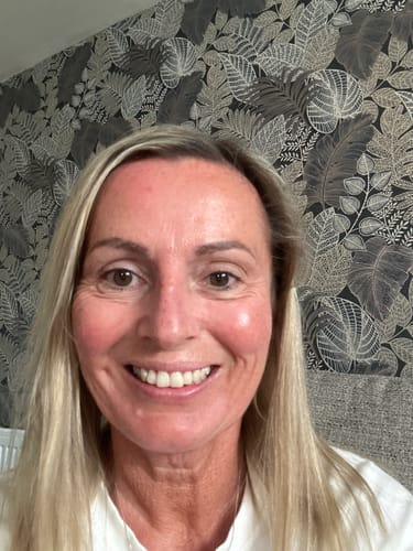 Reviewer smiling, showing clear and radiant skin after using the 5-Step Clear Skin Kit.