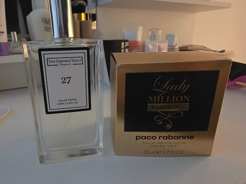 Customer's bottle of 'Inspired by Lady Million - 27' perfume shown next to a gold Lady Million box for comparison.