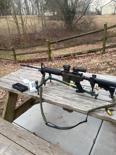 Customer's rifle on a shooting rest on a table, with the Site Right™ 2.0 - Boresighter box nearby.