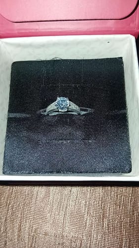 Customer's Silver Solidarity Ring with a central zircon, shown in its black presentation box.