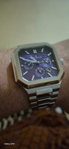A customer's Oceaneva Tenuis watch, showing the purple calendar dial and stainless steel bracelet on their wrist.