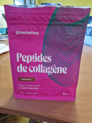 Le sachet rose de Peptides de Collagène saveur chocolat d'un client, posé sur une table.