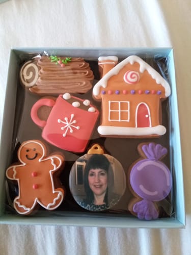 Reviewer's Picture Perfect Biscuit Box with the decorated Gingerbread House set, including the personalized photo biscuit.