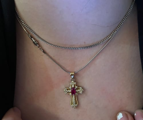Close-up of a customer wearing the 2mm Thin Cuban Link Chain layered with another necklace on their neck.