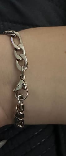 Close-up of a customer wearing the silver Figaro Link ID Bracelet, focusing on the clasp.