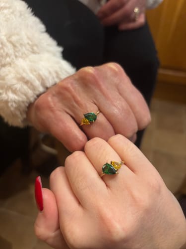 Customer and her mum showing their matching Leesha Birthstone Rings with green and yellow stones.