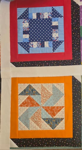 Reviewer's two finished quilt blocks from the Mrs Quilty Subscription Box, sewn together for a larger project.