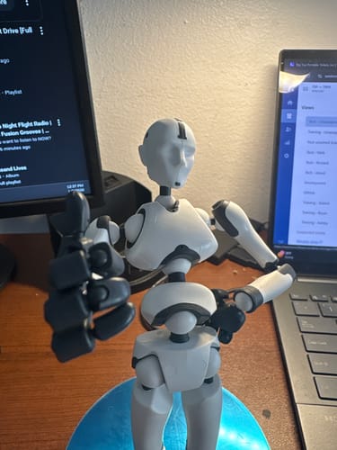 Reviewer's white and black Stickybones figure giving a thumbs-up pose on a desk.