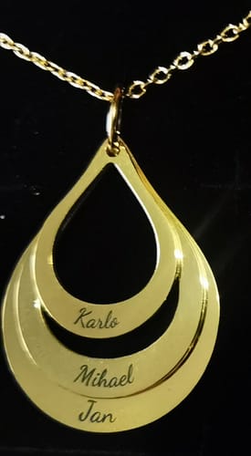 Reviewer's photo of the gift: a gold teardrop pendant necklace engraved with three names.