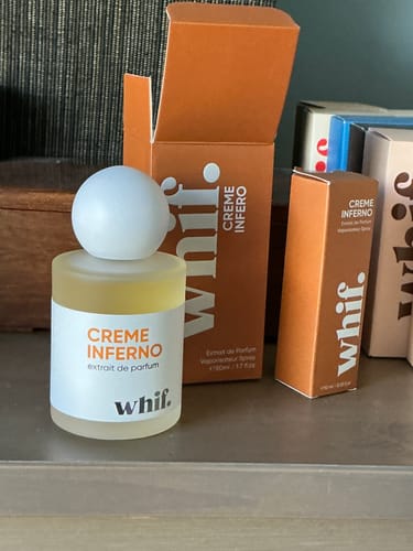 Reviewer's large bottle of Creme Inferno shown next to the smaller travel-size box.