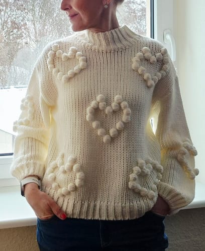 Reviewer wearing the cream chunky knit jumper with a high neck and heart bubble pattern.