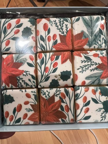 Customer's Christmas Berries Tiles Biscuit Box showing nine square biscuits with festive poinsettia and berry prints.