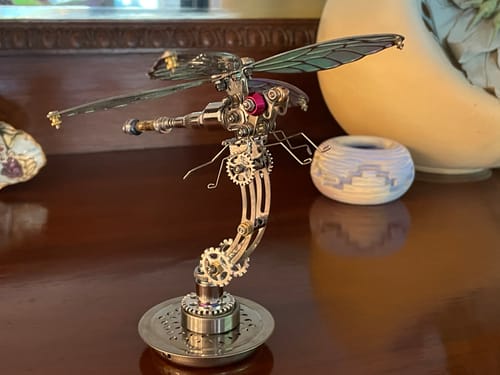 Customer's assembled metallic Dragonfly model with iridescent wings on its display stand.