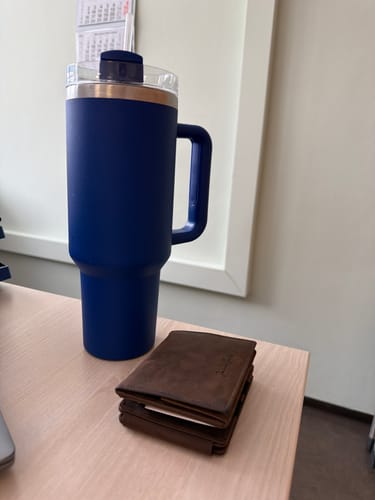 Customer's brown leather Flap Boy XL wallet shown closed on a desk.