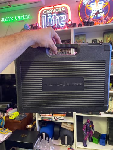 Customer holding the black, sturdy carrying case for the Elite Gun Cleaning Kit.