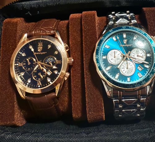Customer's two Lucky Fours® Chronometer watches in a case, one with a brown leather strap and the other with a stylish blue face.