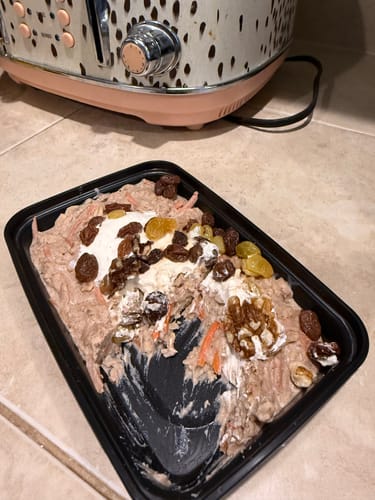 Customer's partially eaten Carrot Cake Oatmeal in its container, showing walnuts, raisins, and yogurt toppings.