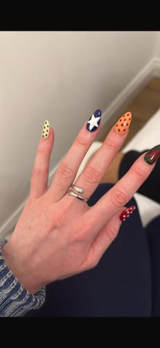 A customer's hand wearing the silver To My Granddaughter - Hug Ring on their finger.