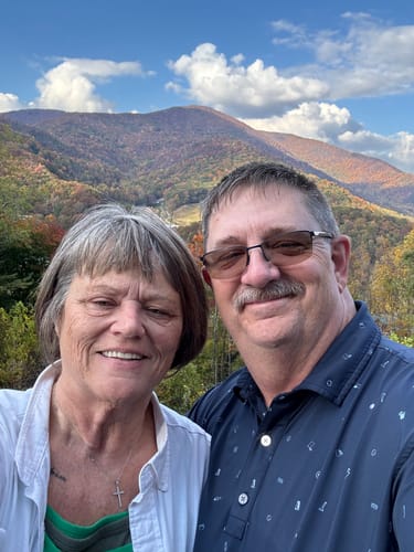 Customer and a companion smiling for an outdoor photo, showing the customer's facial skin after the skin scan service.