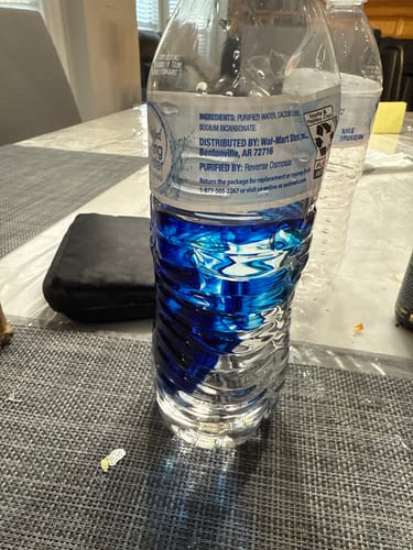 Customer shows Meraki Blu Methylene Blue mixed into a clear water bottle, creating a deep blue color.