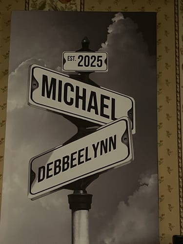 Customer's personalized COUPLES DATE OF LOVE canvas showing street signs with the names Michael and Debbeelynn in black and white.