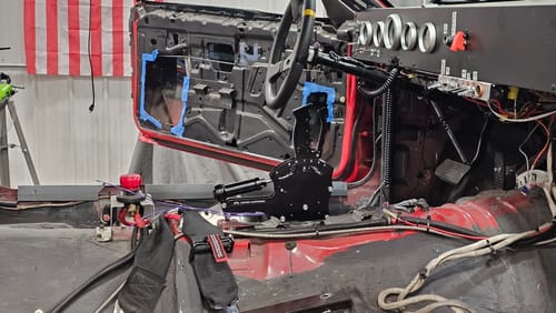 Customer's 4L80E Billet Shifter installed in the stripped-down interior of a race car.