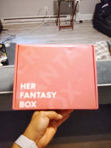 Customer's hand holding the pink box containing The Everything Bundle.