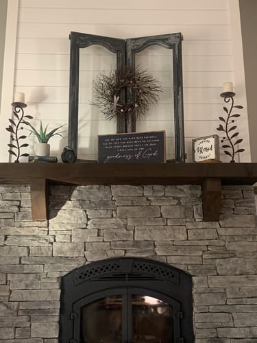 Customer's Goodness Of God Faith Sign styled on a dark wood mantel above a stone fireplace.