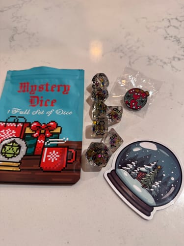 Customer photo review of Holiday Mystery Dice Set – Loads of unique holiday dice stickers and pins!