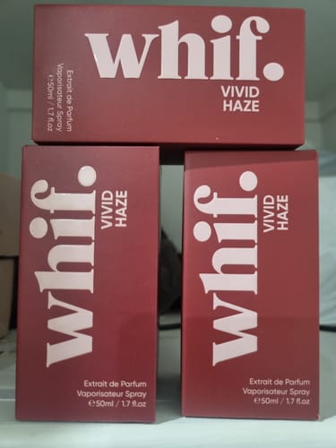 Reviewer's three dark pink boxes of whif. Vivid Haze Extrait de Parfum stacked together.