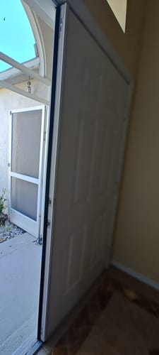 Customer's white Thermal Aluminum Astragal with black weatherstrip installed on the edge of an open interior door.