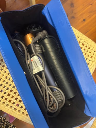 Reviewer's open blue Margot Hair Tool Travel Case filled with a hair tool and multiple attachments.