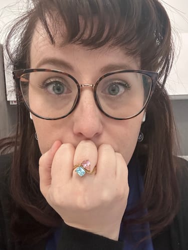 Customer wearing their Navae Birthstone Ring, showing off its pink and blue stones.